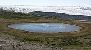 Kettle (round glacial eye-shaped lake), highlands of Isunngua, Greenland.