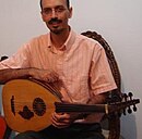 Hossein Behroozinia holding a Persian Barbat