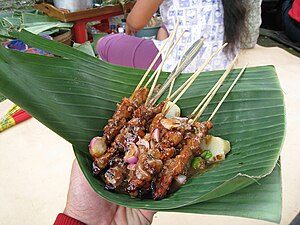 Banana leaf as disposable plate for chicken satay in Java