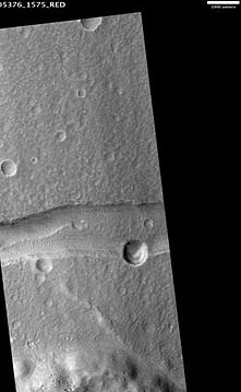 Graben in Memnonia Fossae, as seen by HiRISE. This graben is believed to be the result of magmatic dikes rather than regional tectonic stretching. The scale bar is 1000 meters long.