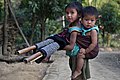 Image 52In Bangladesh there are many tribal people live in Sylhet, Dinajpur, Cox's Bazar, Mymensingh, Rajshahi etc. But majority of tribal people live in the Chittagong Hill Tracts. This picture features a tribal kid with her little sister tied in her back at Farukpara, Bandarban, Bangladesh. Photo Credit: Mohammad Rakibul Hasan