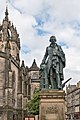 Bronze statue of Adam Smith, a philosopher during the Scottish Enlightenment, in front of St. Giles' Cathedral on the Royal Mile in Edinburgh designed by Alexander Stoddar. June 2014.