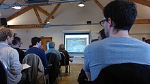 TetZooCon attendees listening to a presentation on pygmy elephants