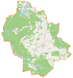 Mapa konturowa gminy Brusy, blisko lewej krawiędzi znajduje się owalna plamka nieco zaostrzona i wystająca na lewo w swoim dolnym rogu z opisem „Laska”