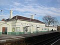 The single-storey building on the Up platform, no longer in use, and the Shere FASTticket self-service ticket machine