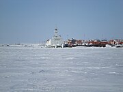 Tug and barges overwintering in Cambridge Bay after the annual sealift