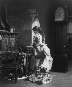 "Sarony's Centennial Tableaux", showing young woman making U.S. Flag on sewing machine, c. 1876