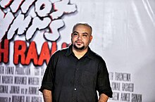 Ahmed Shakir attending the red carpet event of his film "Gohraalhu" wearing a black shirt.