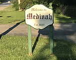 Monument sign on Irving Park Road welcoming drivers to Medinah, Illinois.