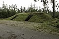 Grassy mound with two inlets for doors at its base