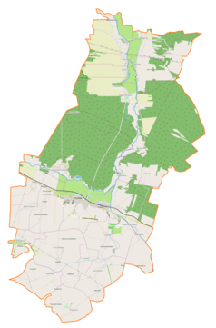 Mapa konturowa gminy Ćmielów, blisko centrum na dole znajduje się ikonka zamku z wieżą z opisem „Zamek w Ćmielowie”