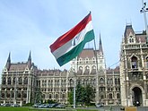1956 Revolution Flag flying in front of the Hungarian Parliament Building