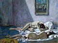 Two women reclining on a bed