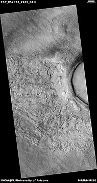 Wide view of fractured surface and pits along wall of crater, as seen by HiRISE under HiWish program