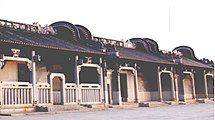 A row of wok yi uks in Fadou District, Guangzhou: Each house has a pair of curved walls protruding vertically at both ends of its roof.