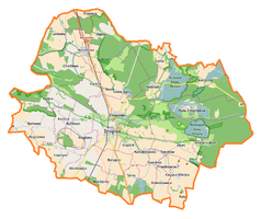 Mapa konturowa gminy Żmigród, blisko centrum po prawej na dole znajduje się punkt z opisem „Osiek”