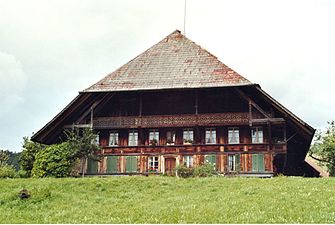 Emmental farmhouse with overhang reaching the ground, Switzerland.