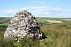 Mound of stones with fields in the background.