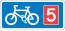 Rectangular, blue traffic sign with a white bicycle symbol and a red square with the number 5 in it.