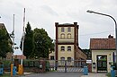 Gutsanlage mit Gutshaus und altem Zufahrtstor, Werkstattgebäude, Remise mit Wohnhaus, Stall- und Wirtschaftsgebäude mit Wasserturm, Kartoffelkeller sowie Kulturhaus und Skulptur der lesenden Studentin (heute Oberstufenzentrum)