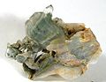 Clear, tabular quartz crystal with a sharp phantom inside demarcated by its mossy green chlorite inclusions