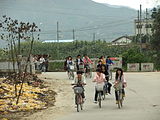 Children returning home from school by bicycle in Xiazhai, China
