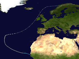 Path of a hurricane, with colored dots representing the storm's intensity at different positions in six-hour intervals. The storm begins in the lower-centre of truck the upper-right corner of the image. The colored dots reflect a gradual increase and then decrease in intensity.