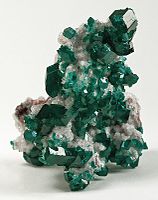 Dioptase crystals on calcite, a classic Tsumeb specimen. Size: 8.2 x 5.8 x 5.5 cm