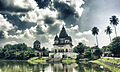 Image 43The pictured Shiva Temple is situated in Puthia Bazar of Rajshahi District. It was built on a hing plinth on the southern bank of a large tank. The temple is a 19.81 meter square building and total height is 35.03 meter. It is a Pancha Ratna type building consists of a Garbhagriha and a surrounding verandah. Rani Bhubanmoye Debi built this temple in 1823 AD. Photo Credit: Nasir Khan Saikat