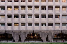 West-facing facade of the Weaver Building with load-bearing concrete pilotis on the first floor and 4 upper floors.