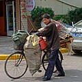 A man hauling scrap by bicycle in China