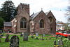 Reddish building with square tower.