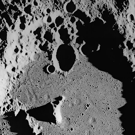 Ghost craters on the surface of the Cayley Formation in the bottom of Albategnius crater. Albategnius B crater (above center) is approximately 15 km across. Subdued troughs trending north-northwest may be buried Imbrium sculpture. The Cayley Formation may be mantling fresh craters to produce a subdued flatbottomed bowl shape.