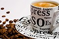 A cup of Espresso and coffee beans