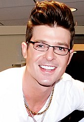 A close-up of Robin Thicke, smiling towards the camera.