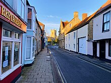 View of the Causeway, a narrow street in Bicester, showing historic buildings on either side.