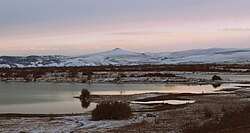 Mount Kharaty, a natural monument, as seen from the selo of Dzhida