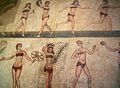 Famous "bikini girls" mosaic (found by archeological excavation of the ancient Roman villa near Piazza Armerina in Sicily), showing women exercising, running, or receiving the palm of victory and crown (for winning an athletic competition).