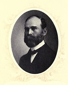 Oval-frame portrait on yellow background of adult male with full beard