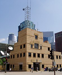 sandstone tower with square windows on the corner of the Nicollet Mall