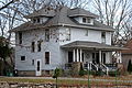 Image 2A wood-frame American Foursquare house in Minnesota with dormer windows on each side and a large front porch