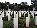 Commonwealth war grave headstones and the Cross of Sacrifice, looking south-east (2021).