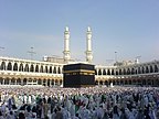 The Kaaba, a large cuboidal building located inside the Masjid al-Haram, is one of Muslims' holiest places. This picture taken from the gate of King Ibn Saud of Saudi Arabia, seems to to divide the Kaaba and the minarets into mirror images of one another.