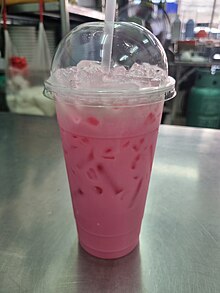 Nom Yen, a bright pink drink in a plastic cup