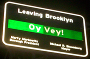Sign leaving Brooklyn on Williamsburg Bridge saying "Leaving Brooklyn: Oy Vey!"