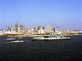 Tripoli leads a ship parade followed by landing craft in San Diego Bay