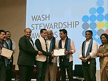 Abhishek Nath receiving the WASH Stewardship Award by K. T. Rama Rao former Minister of MA&UD, IT&EC