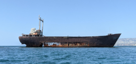 The ship is covered in rust and the central bottom part has many holes.