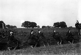 Foot dragoons armed with their carbines protecting themselves in a ditch, in 1912.