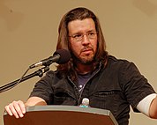 David Foster Wallace speaking at a podium